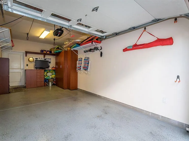 Electric garage door up (remote available) and 1 car garage with room for beach toys and chairs.