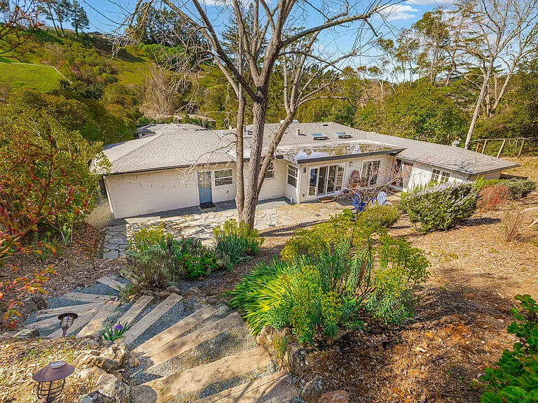 Nature meets privacy tucked into a serene hillside, this home offers peaceful outdoor living with lush landscaping, stone pathways, and plenty of space to unwind or explore.