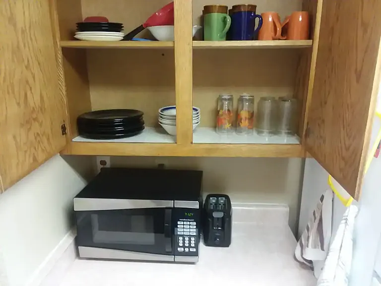 Microwave, toaster, cups, mugs, plates and bowls provided.