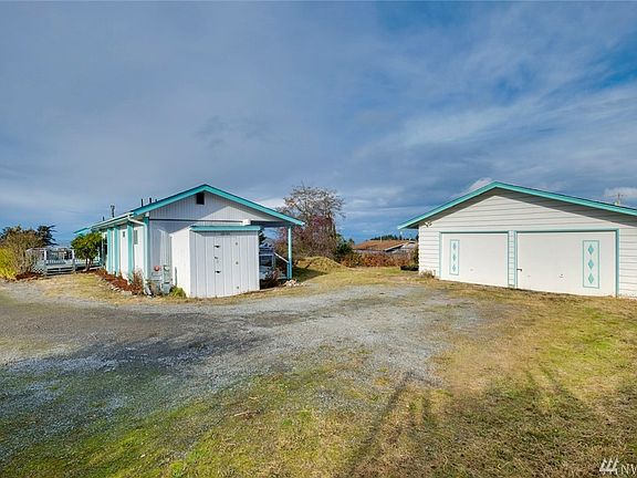 Two car detached garage sits snuggly behind the home. 