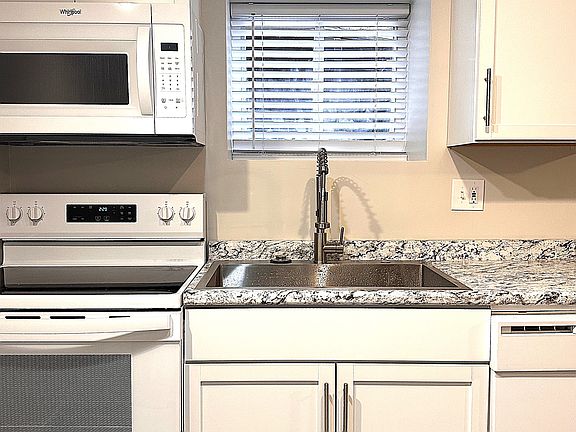 All New Kitchen 
NEW: Smooth Top Range, Vented Microwave, New Cabinets, New Sink & Faucet New Countertop & Full size Dishwasher