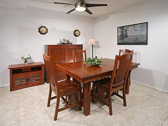 The formal dining room with lighted ceiling fan fi