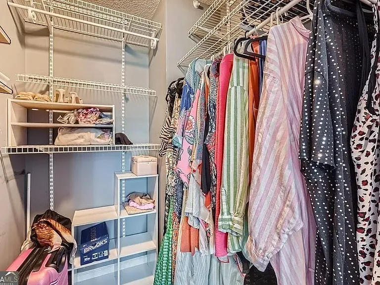 Walk-in closet with shelving and storage units