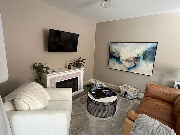 front room with an electric fireplace (not included)