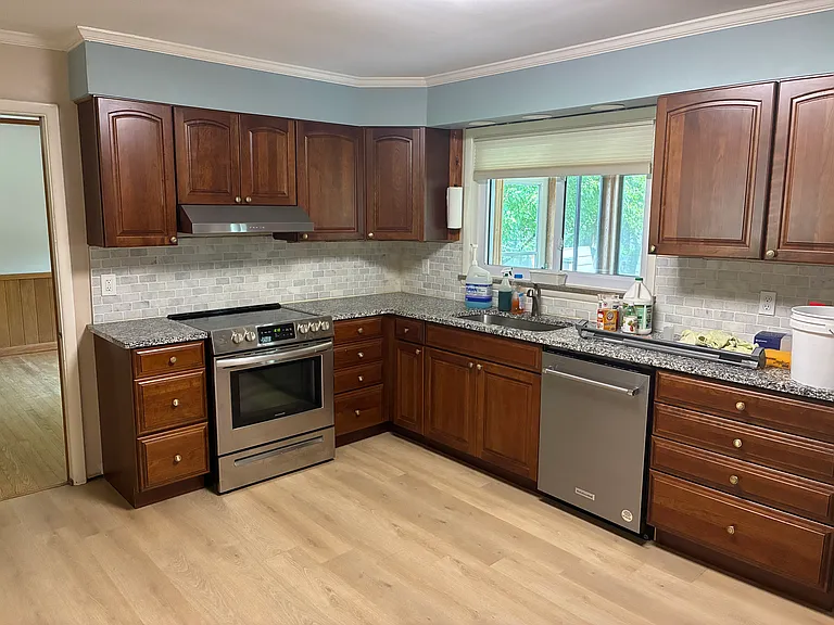 New kitchen floor with newer appliances and granite counter tops.