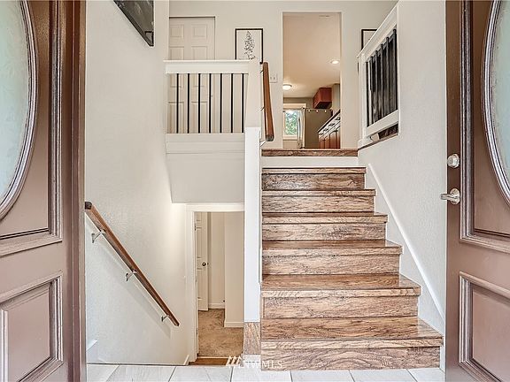 Double Door entry to a tile entry and laminate stairs