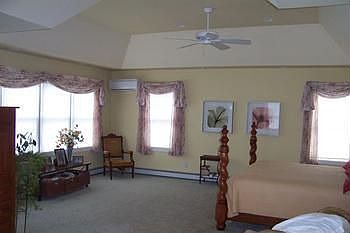 Large Master bedroom with sitting area, doorwall leading to balcony overlooking the lake, adjoining bath with walk-in shower and jacuzzi tub, granite tile counters, vaulted ceilings and much more!