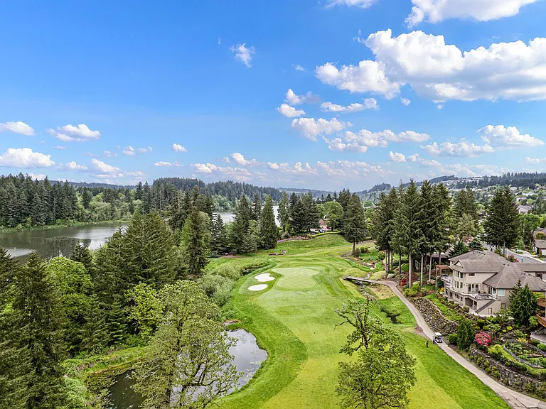 Aerial of fairway and green as well as home