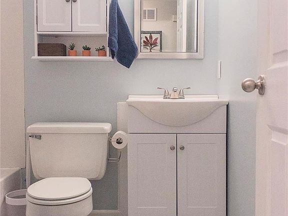 Updated bathroom with new vanity, flooring, fixtures, and fresh paint.