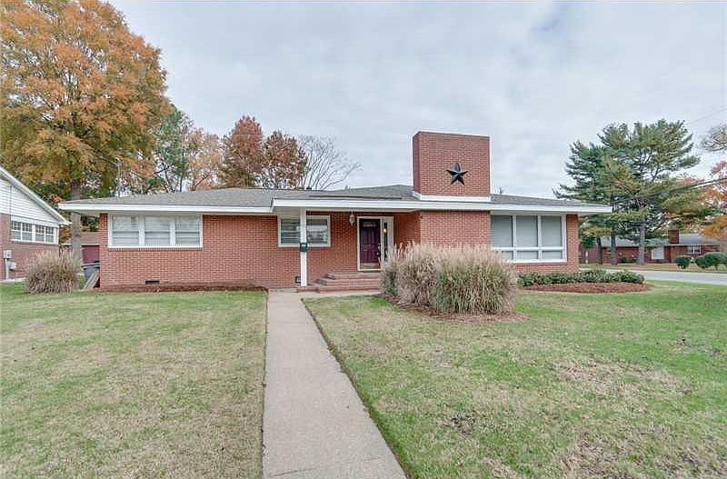 Newly remodeled brick rancher with concrete walkway and open