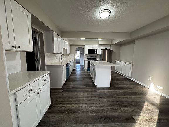 Kitchen looking towards dining room with family room behind