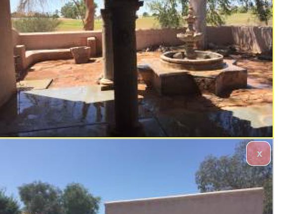 Enclosed portion of back yard and angle view of front of hou