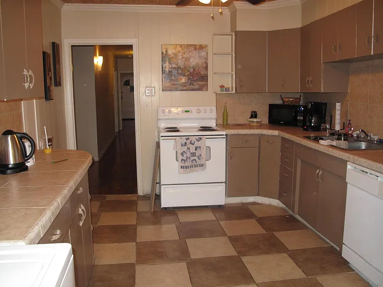 Large kitchen with all appliances (refrigerator, electric stove, dishwasher and disposal. Washer and dryer connections are located in the kitchen