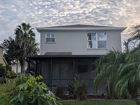 Back of house with lanai and gardens