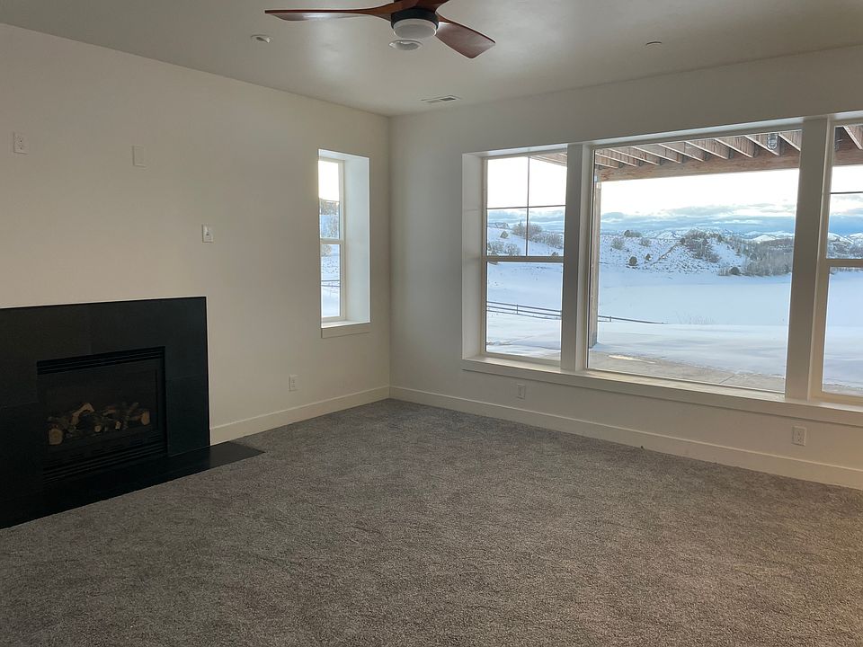 Great room with fireplace and view from apt.