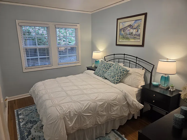 The main floor offers a lovely bedroom with a comfortable queen-sized bed.