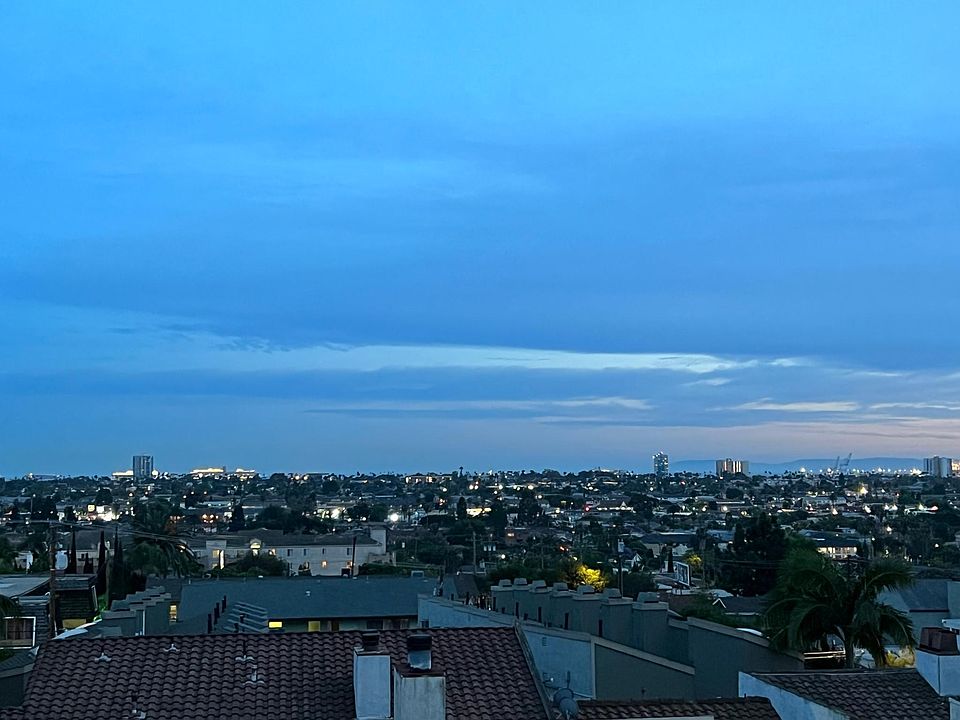 Evening view from the balcony at lights of Long Beach, Cruise ships in the ocean and Catalina island