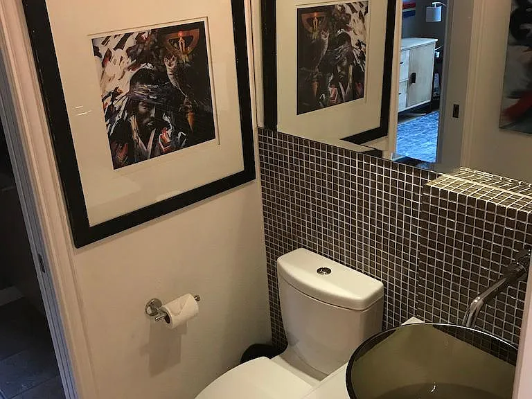 main floor half bath with shower and add'l sink to the left that opens to 2nd bedroom