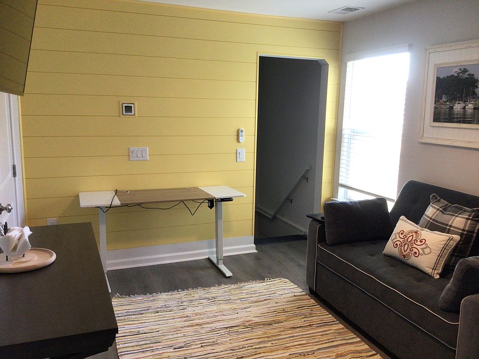 Living area with work table, smart TV, and pull out couch