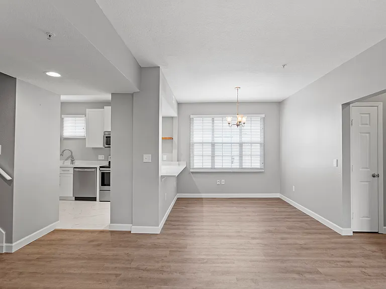 View of the kitchen, bar, and dining room from the living room