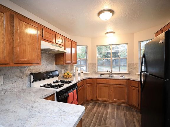 Kitchen showing laminate wood floor (new 2019) and decorative baseboards