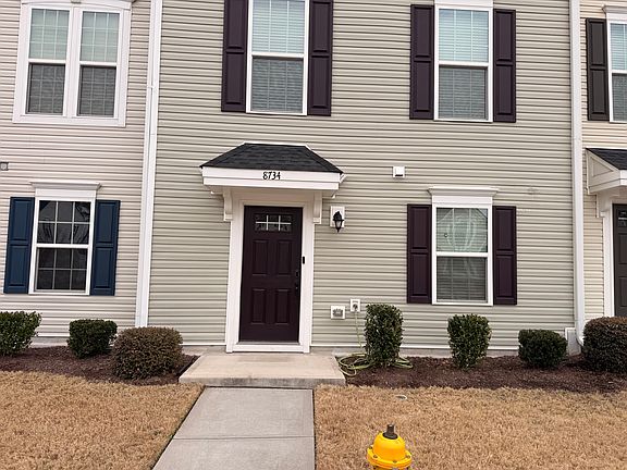 Clean and well-maintained exterior with private entrance, landscaped front area, and welcoming community setting