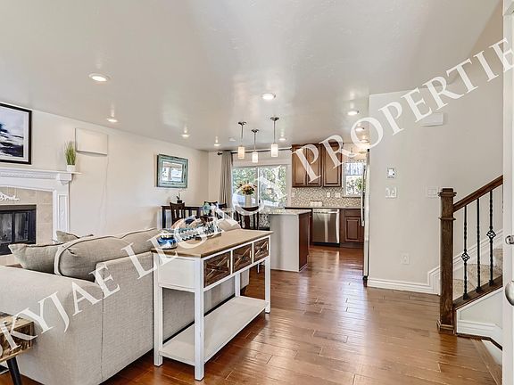 Entrance into the home with large open living room and open kitchen perfect for entertaining. Sliding glass door opens to large deck in backyard.