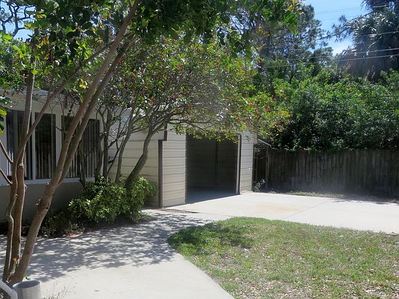 Exterior shot of Florida Room and 2 Car Garage