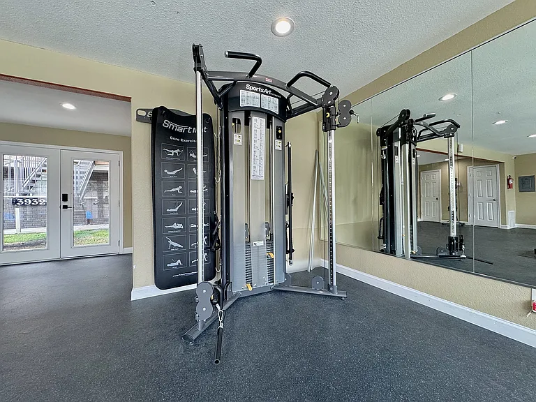 Build strength in the fitness center equipped with resistance machines and mirrored walls.