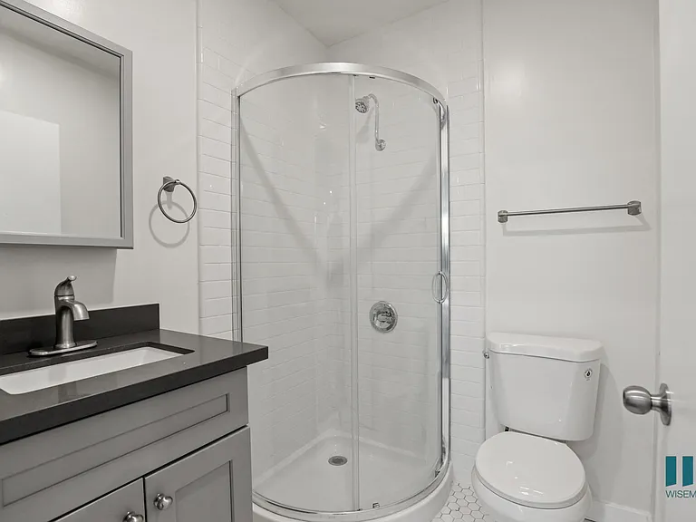 Bathroom with Stand-Up Shower with Glass Door and Vanity Cabinet Storage