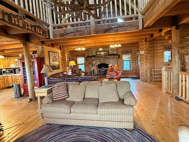 Main floor living room, showing second floor railing