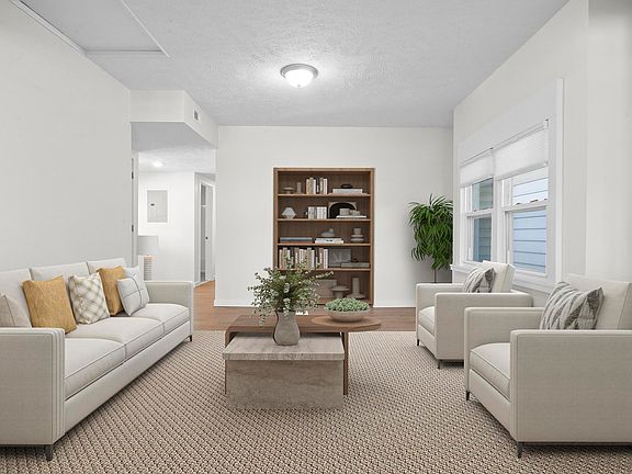 Large living area with hallway back to the left in this image that leads to the bedrooms and balconies. (Unit is leased unfurnished)