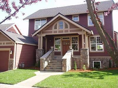 Front of home with beautiful stone porch