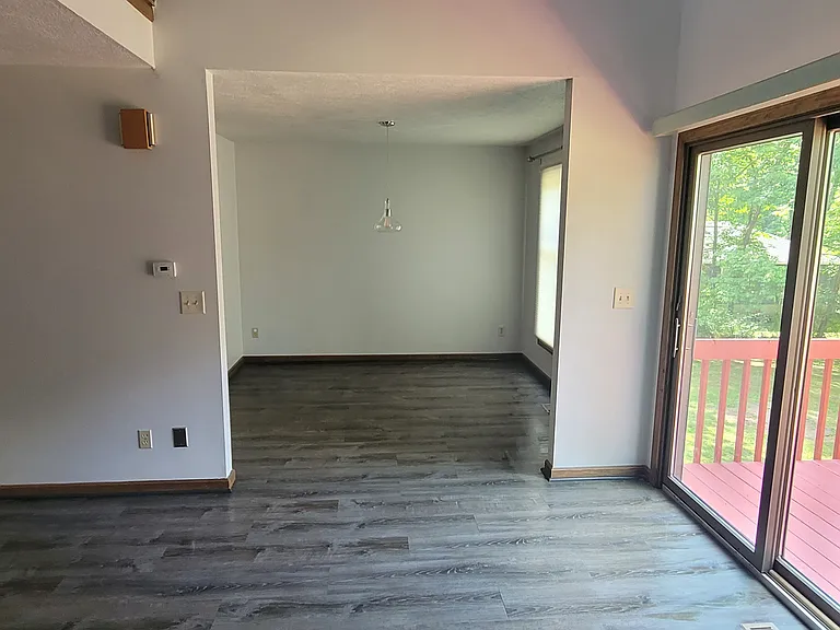View from the living room looking towards the dining room and the balcony.
