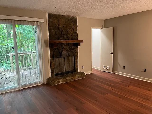 Living Room w/fireplace and indoor storage closet. Sliding door to private back porch.