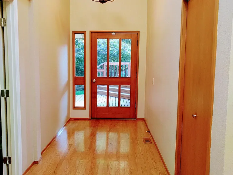 Spacious entryway with closet for coats.