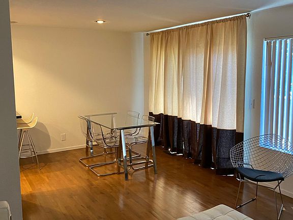 Garden patio is outside living room - through floor to ceiling glass door.