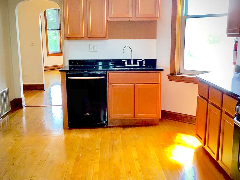 Spacious kitchen includes vintage woodwork and modern appliances.