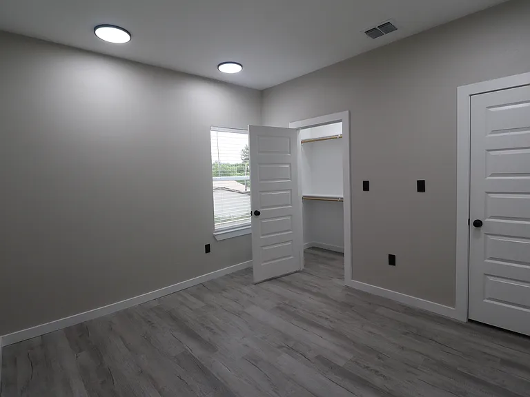 Bedroom 2 of 4 with a spacious closet, contemporary finishes, and a bright, comfortable layout.