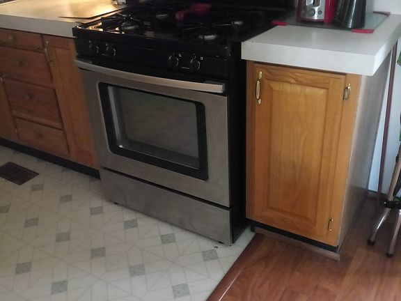 Kitchen is L shaped lots of cabinets