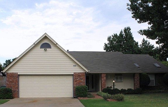 Open driveway and two car garage