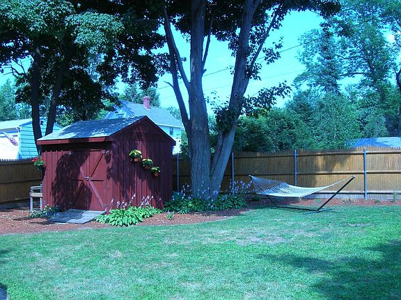 Private, fenced yard with mature maples.