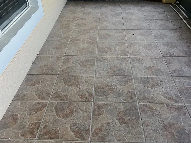 50 - Tiled corner space near window, ideal for breakfast nook or reading area.