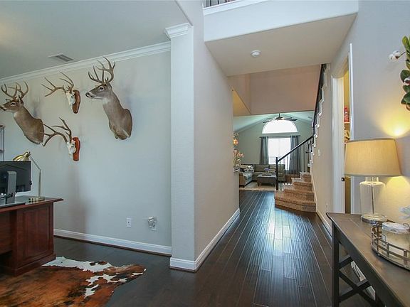 As you enter the home, you will notice the rich wood flooring, nice neutral grey paint, and crown moldings.