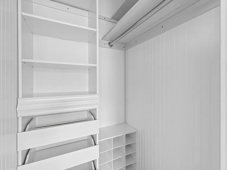 The custom walk-in closet in the primary bedroom offers ample storage and organization.