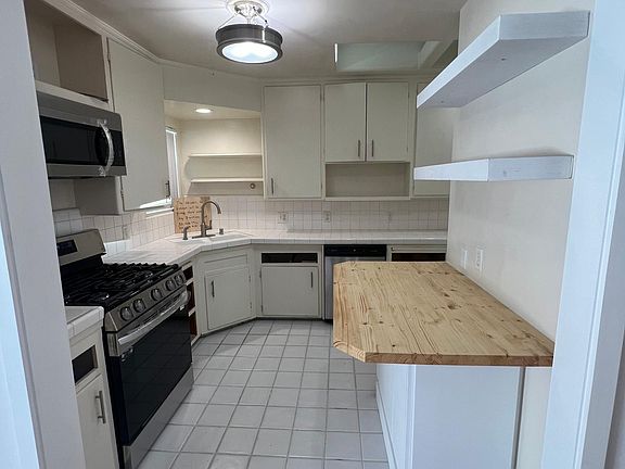 Slightly updated area to kitchen. Cabinets beautiful butcher block and floating shelves. 

(Cabinet drawers getting sliders put on and will have picture update shortly)