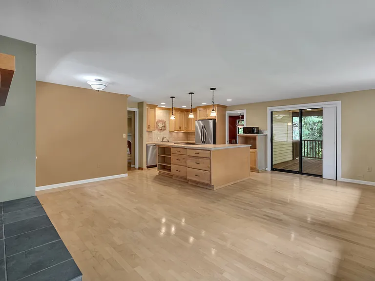 BIG family room with fireplace. Notice the slider to the deck.