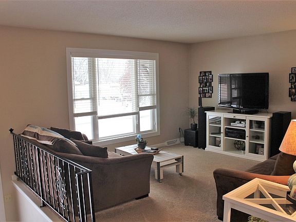 Living room with large picture and sliding window.