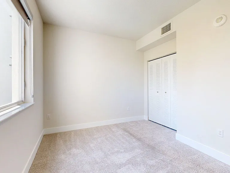 Spacious apartment Bedroom with Carpet Floor.