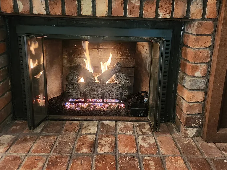 I'll switch on the gas log fireplace so you can imagine having hot chocolate by the fire on a cold winter night.